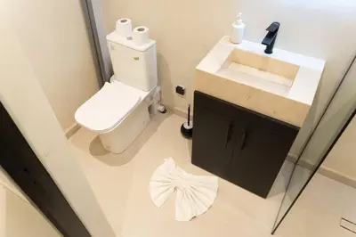 a bathroom with a white toilet and a sink at Studio Chic Coeur de Gueliz in Marrakech