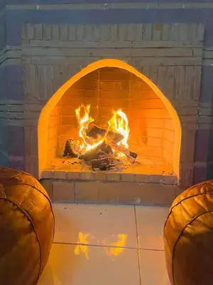 a fire burns in a brick oven with two basketballs at Vue Fontaine appart in Marrakech