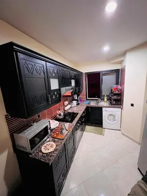 a kitchen with a sink and a microwave on a counter at Vue Fontaine appart in Marrakech