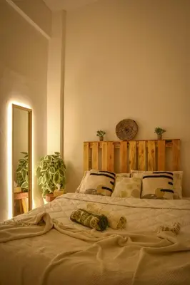 a bedroom with a large bed with a wooden headboard at Quiet apartment of traditional Moroccan in Marrakech