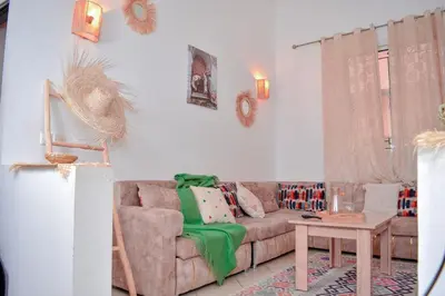 a living room with a couch and a table at Quiet apartment of traditional Moroccan in Marrakech