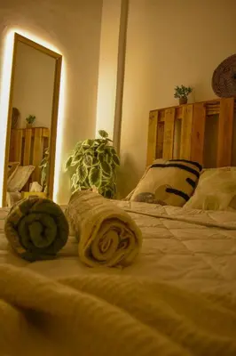 a bedroom with a bed with two rollers on it at Quiet apartment of traditional Moroccan in Marrakech