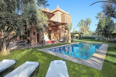 a backyard with a pool and a house at Lankah - Authentic villa with private heated pool close to city center in Douar Caïd Layadi
