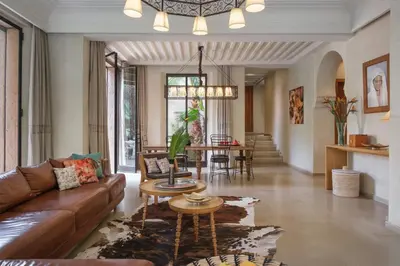 a living room with a couch and a table at Lankah - Authentic villa with private heated pool close to city center in Douar Caïd Layadi