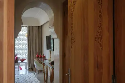 a hallway with a dining room with a table with chairs at Lankah - Authentic villa with private heated pool close to city center in Douar Caïd Layadi
