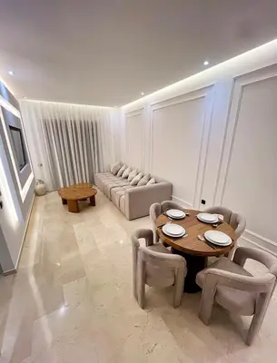 a living room with a couch and a table and chairs at Luxury Apartment & Atlas View in Marrakech