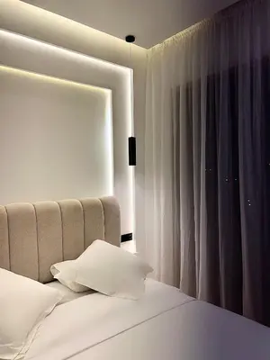 a bedroom with a white bed with a window at Luxury Apartment & Atlas View in Marrakech