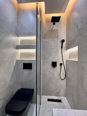 a bathroom with a shower with a black toilet at Luxury Apartment & Atlas View in Marrakech