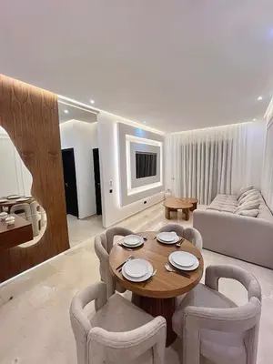 a living room with a table and chairs and a couch at Luxury Apartment & Atlas View in Marrakech