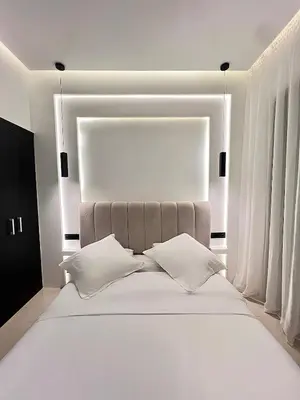 a bedroom with a white bed with two pillows at Luxury Apartment & Atlas View in Marrakech
