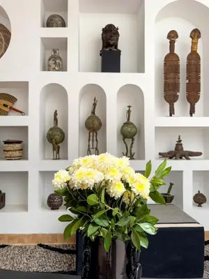 a room with a vase of flowers on a table at Riad Akwaba Charm and Comfort in Marrakech