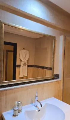 a bathroom sink with a large mirror above it at La Terrasse in Marrakech