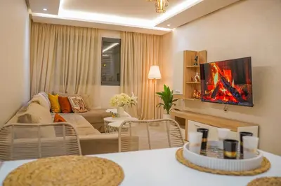a living room with a couch and a table at GYM POOL Flat Marrakech Central City in Marrakech