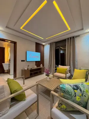 a living room with a couch and a tv at Villa Privèe avec Piscine Chaufèe à 5min de Gueliz in Marrakech