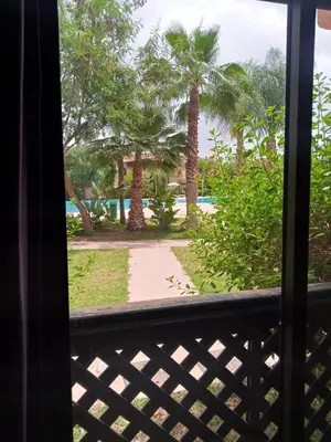 a view from a window of a beach with palm trees at Dar Saad Atlas golf in Marrakech