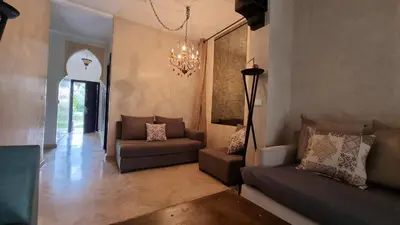 a living room with couches and a chandelier at Dar Saad Atlas golf in Marrakech