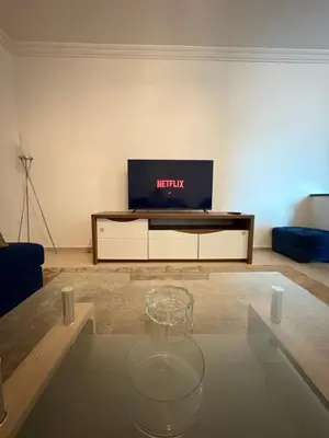 a living room with a coffee table and a tv at Albaraka building in Marrakech