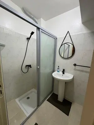 a bathroom with a shower and a sink at Albaraka building in Marrakech
