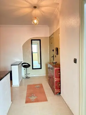 a room with a kitchen with a table and a stool at Albaraka building in Marrakech