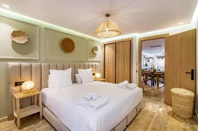 a bedroom with a white bed with towels on it at La Parenthèse Urbaine - Patio Berbère in Marrakech