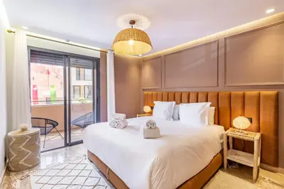 a bedroom with a large bed with towels on it at La Parenthèse Urbaine - Patio Berbère in Marrakech