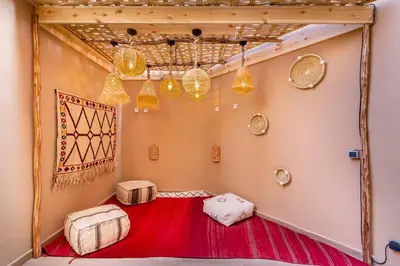 a room with a red carpet and chandeliers at La Parenthèse Urbaine - Patio Berbère in Marrakech