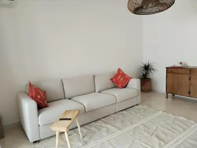 a living room with a couch and a table at White in Marrakech