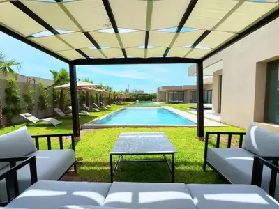 a view of the pool from the patio of a villa at Villa Signature - Élégance , Confort en Double in Marrakech