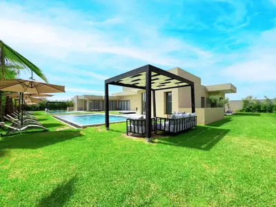 a backyard with a pool and a house at Villa Signature - Élégance , Confort en Double in Marrakech