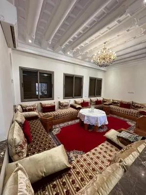 a large living room with couches and a table at Villa Benben 6 minutes du Grand Stade de Marrakech in Marrakech