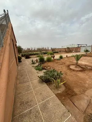 a garden with plants on the side of a building at Villa Benben 6 minutes du Grand Stade de Marrakech in Marrakech