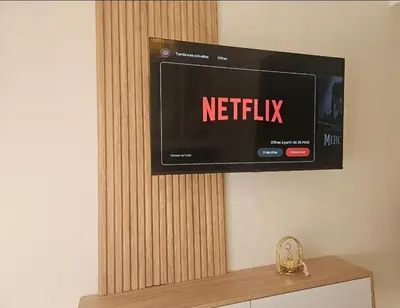 a television on a wall with a netflix sign on it at Appartement cosy hivernage piscine in Marrakech
