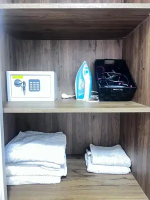 a shelf with a microwave and towels on it at Appartement neuf et moderne Marrakech in Marrakech