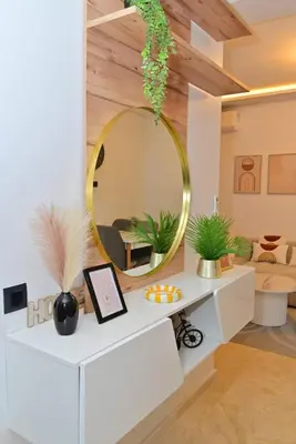 a living room with a mirror on the wall at Appartement neuf et moderne Marrakech in Marrakech