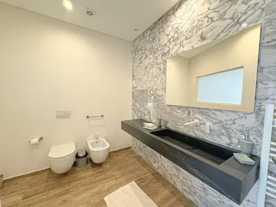 a bathroom with a sink and a toilet and a mirror at Villa Leonardo in Marrakech