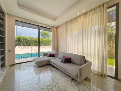 a living room with a couch and a large window at Villa Leonardo in Marrakech