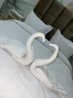 two white towels laying on top of a bed at votre parfait sejour in Marrakech