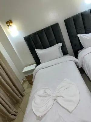 a bedroom with a white bed with a bow on it at votre parfait sejour in Marrakech