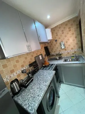 a kitchen with a sink and a washing machine at votre parfait sejour in Marrakech
