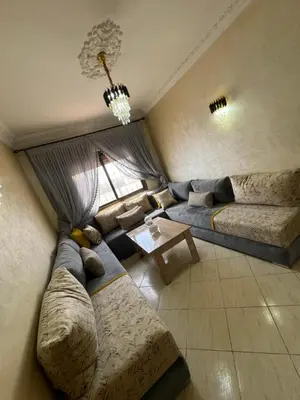 a living room with a couch and a table at votre parfait sejour in Marrakech