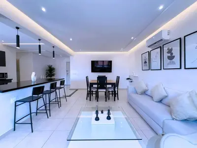 a living room with a white couch and a table at Appart Confort et raffinement au cœur de Marrakech in Marrakech