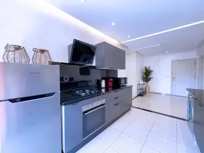 a kitchen with a refrigerator and a stove top oven at Appart Confort et raffinement au cœur de Marrakech in Marrakech