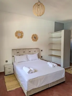 a bedroom with a large white bed with two pillows at Oasis Villa in Marrakech