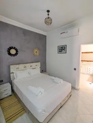 a bedroom with a large white bed in a room at Oasis Villa in Marrakech
