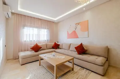 a living room with a couch and a table at Central Marrakech Apart 2 Minutes from M Avenue with Pool & parking & Wifi in Marrakech