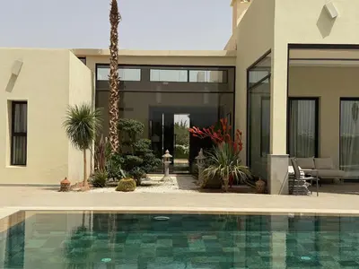 a house with a swimming pool in front of a house at Luxury Villa Pool with Atlas View in Moussiha