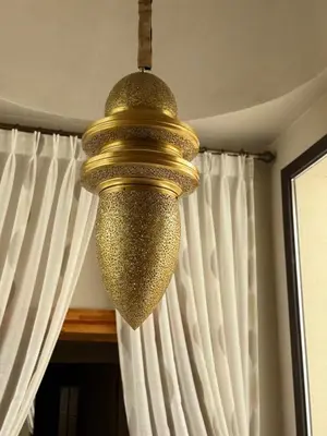 a gold chandelier hanging from a ceiling at Luxury Villa Pool with Atlas View in Moussiha