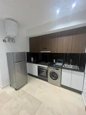 a kitchen with a washing machine and a sink at Leila in Marrakech