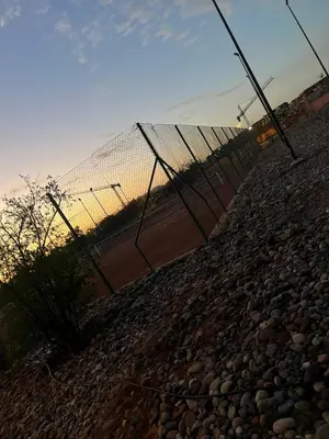 a fence on top of a rocky ground at Almaz appartement in Marrakech