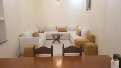 a living room with a white couch and chairs at Home for peace & enjoyment in Marrakech